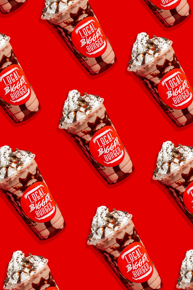 Graphic pattern of branded chocolate milkshakes on red